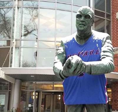 A statue of a man wearing a DePaul sports jersey.